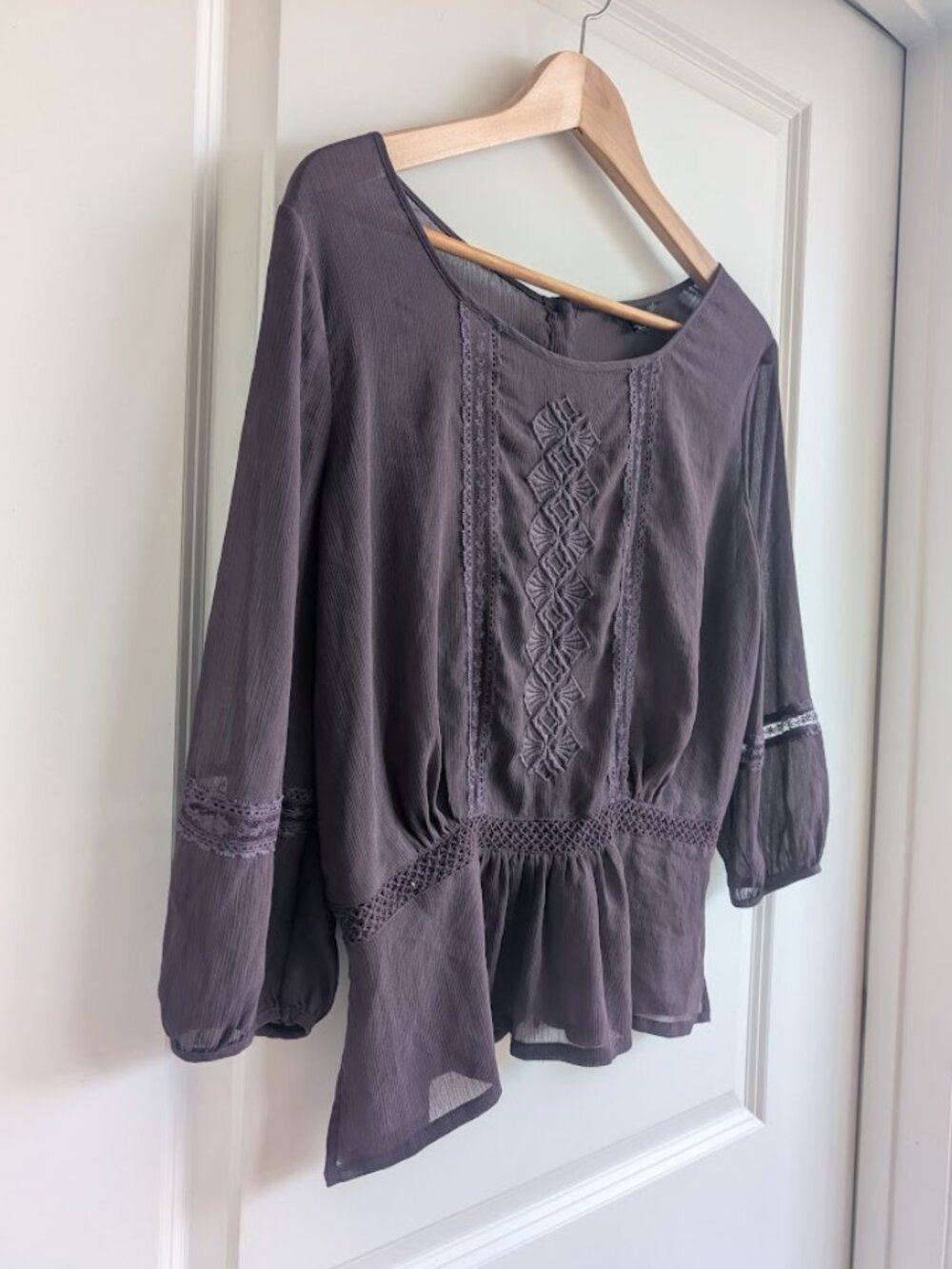 Sheer purple blouse with embroidery detailing.